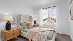 Carpeted bedroom with baseboards and visible vents