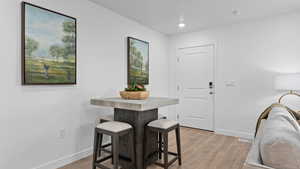 Dining room featuring recessed lighting, baseboards, light wood-style floors, and visible vents