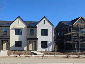 View of front facade with stucco siding and stone siding