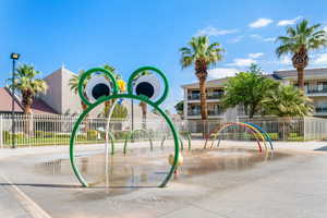 View of jungle gym featuring fence