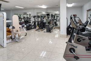 Exercise room featuring tile patterned floors and visible vents