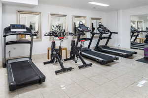 Exercise room featuring tile patterned floors