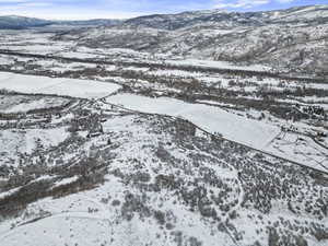 Snowy aerial view featuring a mountain view