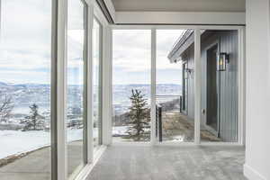 Unfurnished sunroom featuring a mountain view