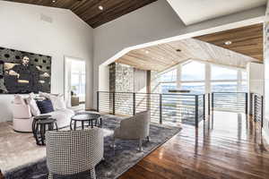 Living room with wooden ceiling, high vaulted ceiling, wood finished floors, and recessed lighting