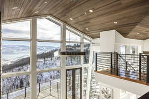 Detailed view of wooden ceiling, recessed lighting, and a mountainous background