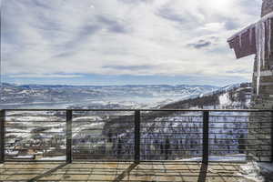 Snow covered patio featuring a mountain view
