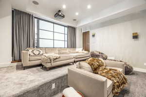 Carpeted living area featuring baseboards and recessed lighting