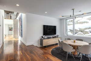 Dining area featuring dark wood-style floors, recessed lighting, and baseboards