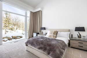 Bedroom with carpet flooring, access to outside, and lofted ceiling