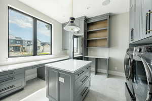Interior space featuring baseboards, cabinet space, recessed lighting, and washer and clothes dryer