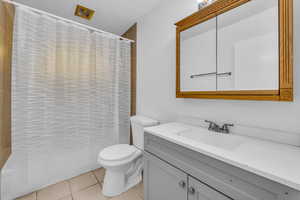 Bathroom with tile patterned flooring, vanity, and toilet