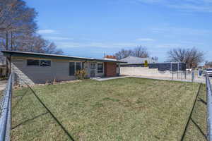 View of front of property with a fenced backyard and a front yard