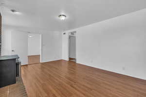 Unfurnished living room with baseboards, visible vents, and light wood-style flooring