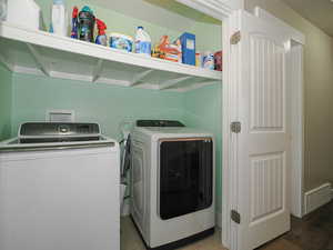 Laundry area with washing machine and dryer, visible vents, and laundry area