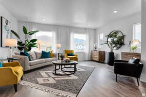 Living area featuring recessed lighting, baseboards, a mountain view, and wood finished floors