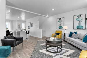 Living room featuring baseboards, light wood-style flooring, and recessed lighting