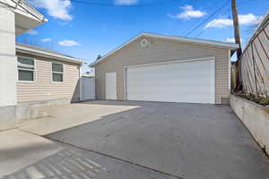 View of detached garage and patio area