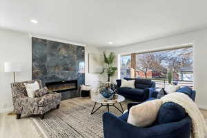 Living area featuring recessed lighting, an electric fireplace, and LVP flooring
