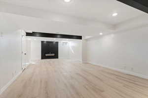 Second family room in basement with electric fireplace