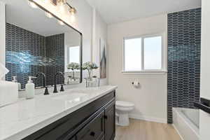 Full bathroom with a bathing tub, beautiful tile and large vanity