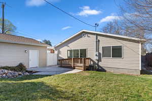 Back of house featuring a patio, a deck, and a yard