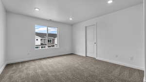 Unfurnished room featuring recessed lighting, carpet floors, baseboards, and visible vents