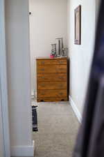 Interior space with baseboards and carpet flooring