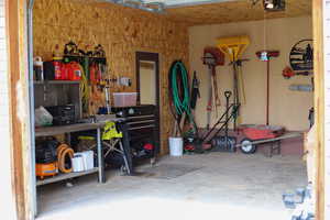 Garage featuring a workshop area and a garage door opener