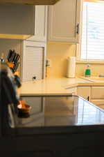 Kitchen with light countertops and white cabinets