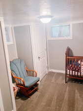 Bedroom with carpet and a textured ceiling