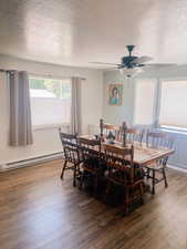 Dining space with a textured ceiling, ceiling fan, a baseboard heating unit, and light wood finished floors