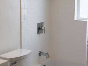 Full bath featuring toilet and shower / bathtub combination with curtain