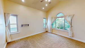 Empty room featuring ceiling fan, high vaulted ceiling, carpet flooring, and recessed lighting