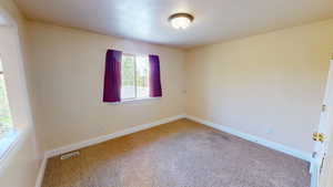Unfurnished room featuring carpet flooring and baseboards