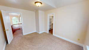 Unfurnished room with light colored carpet and baseboards