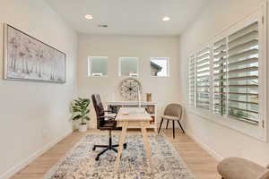 Office space featuring light wood-type flooring, recessed lighting, and visible vents