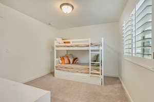 Carpeted bedroom with baseboards