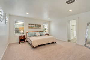 Bedroom featuring recessed lighting, light colored carpet, and visible vents