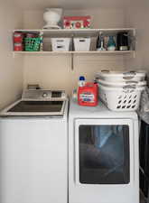 Washroom featuring laundry area and washer and dryer