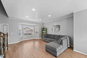 Living area featuring baseboards and light wood-style floors