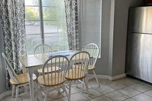 Dining space with tile patterned flooring and baseboards