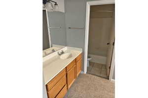Primary bathroom bathroom with toilet, vanity, shower / bathtub combination, and tile patterned floors