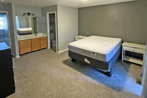 Upstairs Primary bedroom.  Private bedroom #1 with ensuite bath, and carpet
