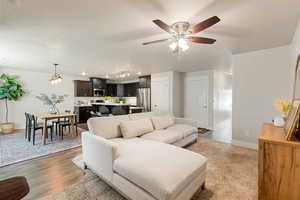 Living area featuring light wood finished floors and a ceiling fan