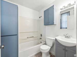 Full bath with tile patterned flooring, vanity, toilet, and tub / shower combination