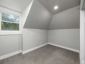 Additional living space featuring baseboards, lofted ceiling, recessed lighting, and carpet