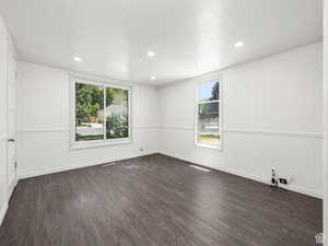 Living Room featuring dark wood finished floors, baseboards, and recessed lighting