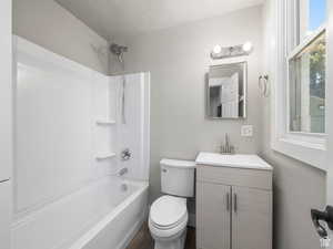 Bathroom with shower / tub combination, toilet, and vanity