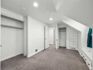 Unfurnished bedroom with baseboards, visible vents, and carpet
